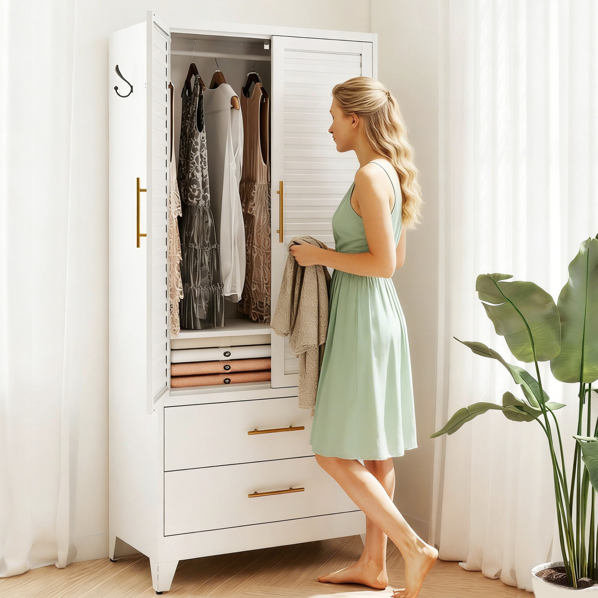 Woman taking clothes from Louvered Wardrobe 71, doors open with clothes on the hanging rod
