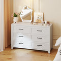 6-Drawer Dresser in Chalk in a bedroom, with a mirror and flowers on top